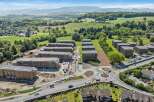Discover modern living in this new construction development featuring multiple apartment buildings with contemporary architecture and solar panels on the roofs.