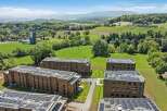 Discover modern living in this expansive residential complex, featuring multiple apartment buildings equipped with state-of-the-art solar panel systems on their rooftops.
