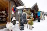 Discover charming winter apparel at this cozy outdoor market stall, perfect for the snowy season.