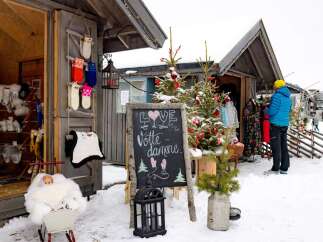 Discover charming winter apparel at this cozy outdoor market stall, perfect for the snowy season.
