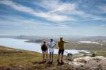 Experience breathtaking panoramic views from this elevated property, featuring a serene lake and vast, rolling hills.
