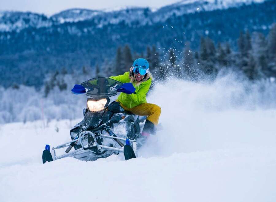 Experience the thrill of winter with this stunning snowmobile adventure.