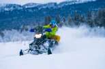 Experience the thrill of winter with this stunning snowmobile adventure.