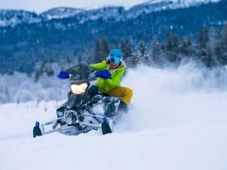Experience the thrill of winter with this stunning snowmobile adventure.