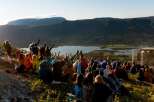 Experience an unforgettable outdoor concert set against a breathtaking mountain and lake backdrop.