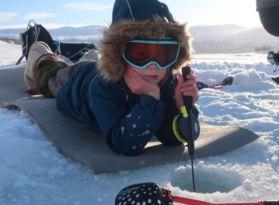 Experience the thrill of ice fishing in this picturesque winter wonderland.