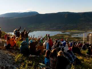 Experience an unforgettable outdoor concert set against a breathtaking mountain and lake backdrop.