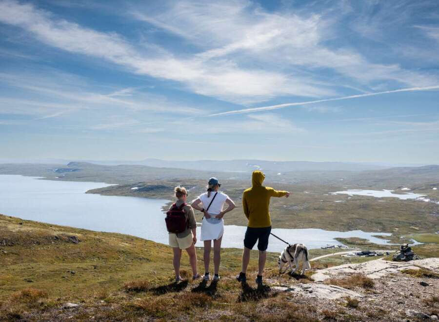 Experience breathtaking panoramic views from this elevated property, featuring a serene lake and vast, rolling hills.