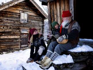 Experience the charm of a rustic log cabin nestled in a snowy landscape, perfect for a cozy winter retreat.