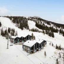 Experience luxury mountain living in these modern ski-in/ski-out chalets, perfectly situated on a snowy slope.