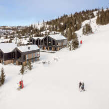 Experience luxury mountain living in this stunning ski-in/ski-out property, featuring modern architecture with expansive windows and natural wood accents.