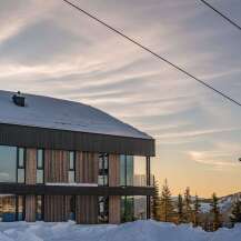 Experience luxury mountain living in this stunning modern ski lodge, perfectly situated amidst a winter wonderland.