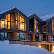 Experience luxury mountain living in this stunning modern chalet, perfectly situated amidst a winter wonderland.