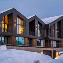 Experience modern luxury in this stunning multi-level home, nestled in a snowy landscape.