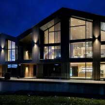 Experience modern luxury in this stunning architectural home, featuring expansive floor-to-ceiling windows that flood the interior with natural light.