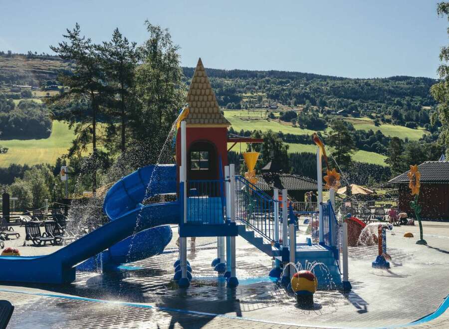 Enjoy a refreshing day at this vibrant water park, featuring a colorful slide and splash pad perfect for family fun.