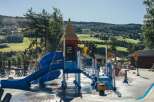 Enjoy a refreshing day at this vibrant water park, featuring a colorful slide and splash pad perfect for family fun.