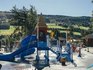 Enjoy a refreshing day at this vibrant water park, featuring a colorful slide and splash pad perfect for family fun.