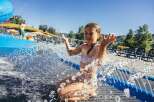 Enjoy a refreshing day at this water park, featuring a thrilling blue water slide perfect for all ages.