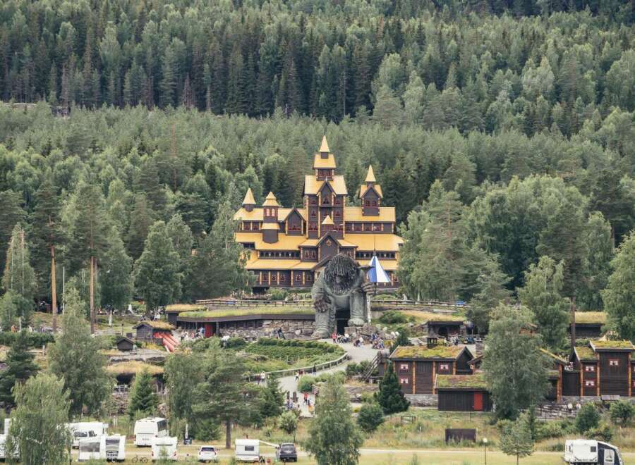 Discover a unique fairytale-like castle nestled amidst a lush, dense forest, offering a whimsical and enchanting atmosphere.