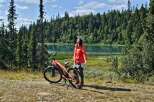 Experience the ultimate outdoor adventure with this stunning property, featuring a serene lake and lush forest backdrop perfect for cycling enthusiasts.