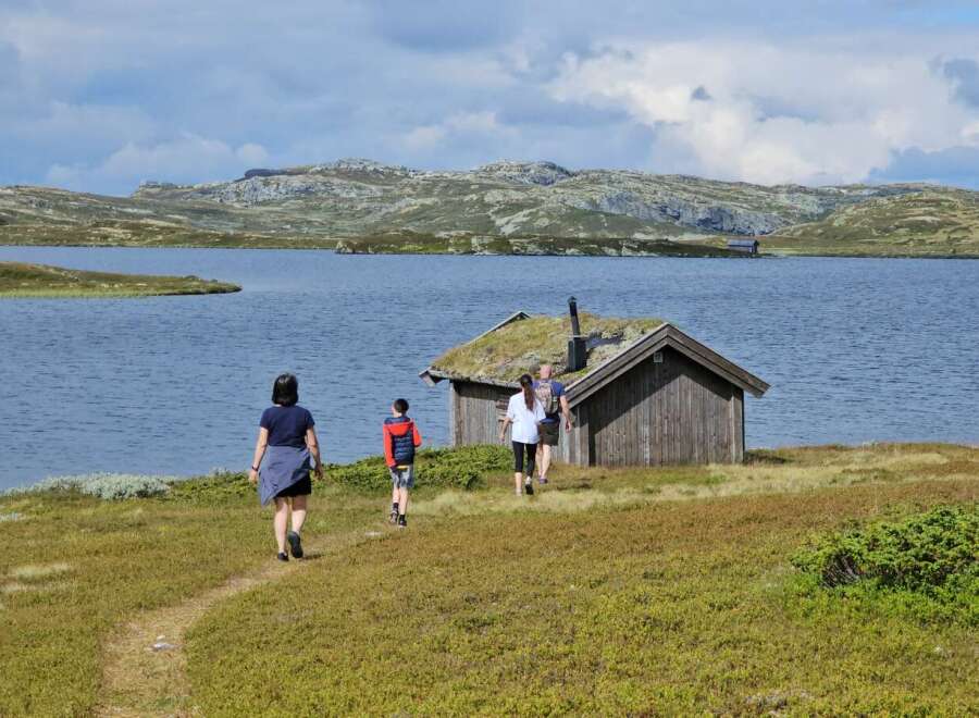 Discover this charming rustic cabin nestled beside a serene lake, offering breathtaking views of rolling hills and a tranquil landscape.