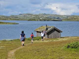 Discover this charming rustic cabin nestled beside a serene lake, offering breathtaking views of rolling hills and a tranquil landscape.