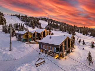 Experience luxury mountain living in these stunning modern chalets, perfectly situated on a ski slope with breathtaking sunset views.