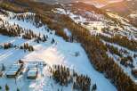 Experience the ultimate mountain lifestyle with this stunning ski-in/ski-out property nestled amidst snow-covered slopes and towering pine trees.