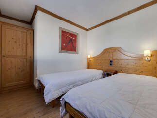 This charming bedroom features two comfortable twin beds, perfect for accommodating guests or family.