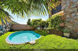 Escape to your private oasis with this charming backyard featuring a sparkling blue pool, perfect for refreshing dips on sunny days.