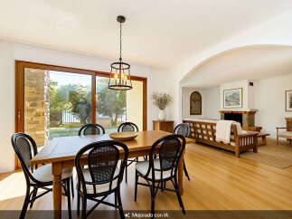 Experience elegant dining in this beautifully appointed space, featuring a warm wooden table and stylish cane-backed chairs.