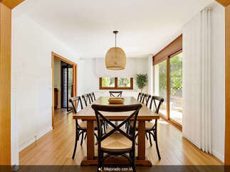 This spacious dining room features a large wooden table surrounded by eight chairs, perfect for family gatherings.
