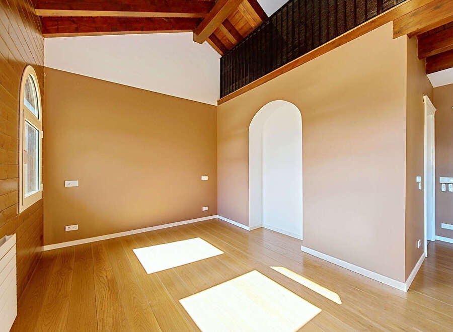 Experience the warmth and natural beauty of this spacious room, featuring rich hardwood floors that gleam under abundant natural light.