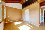 Experience the warmth and natural beauty of this spacious room, featuring rich hardwood floors that gleam under abundant natural light.