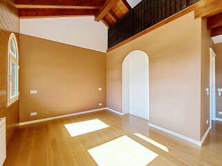 Experience the warmth and natural beauty of this spacious room, featuring rich hardwood floors that gleam under abundant natural light.