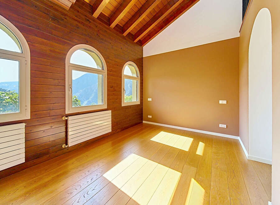 Experience breathtaking mountain views from this stunning room, featuring elegant arched windows that flood the space with natural light.