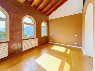 Experience breathtaking mountain views from this stunning room, featuring elegant arched windows that flood the space with natural light.