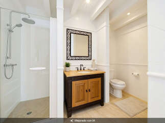 This bright and airy bathroom features a spacious walk-in shower with a modern chrome showerhead and a separate handheld sprayer.