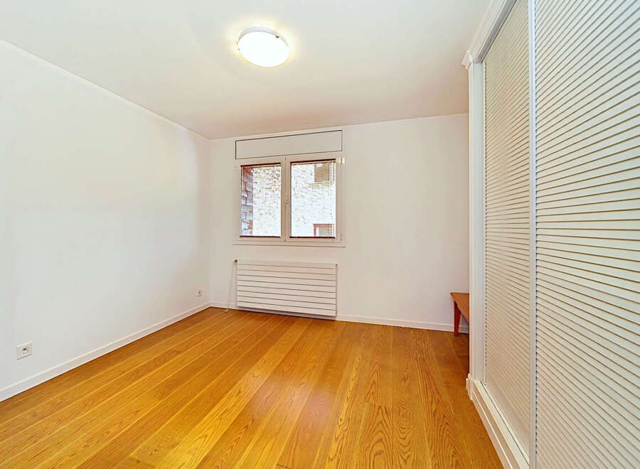 This bright and airy room features a beautiful hardwood floor that gleams under the natural light.