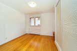 This bright and airy room features a beautiful hardwood floor that gleams under the natural light.