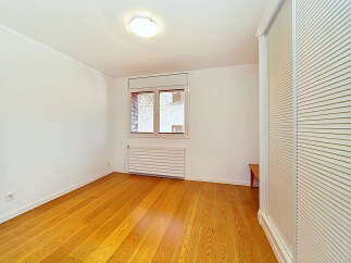 This bright and airy room features a beautiful hardwood floor that gleams under the natural light.