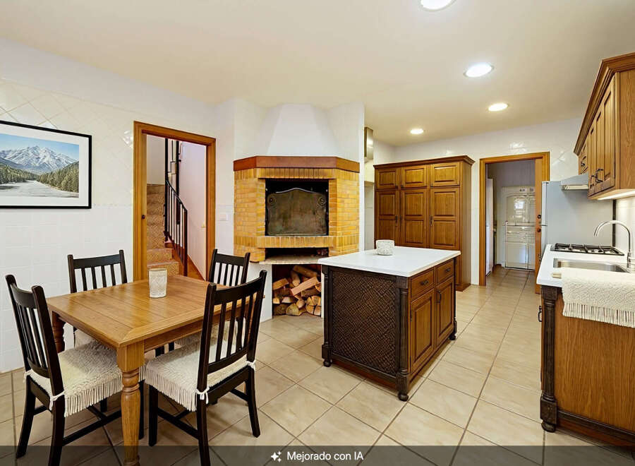 This spacious kitchen boasts a large brick fireplace, perfect for cozy evenings.