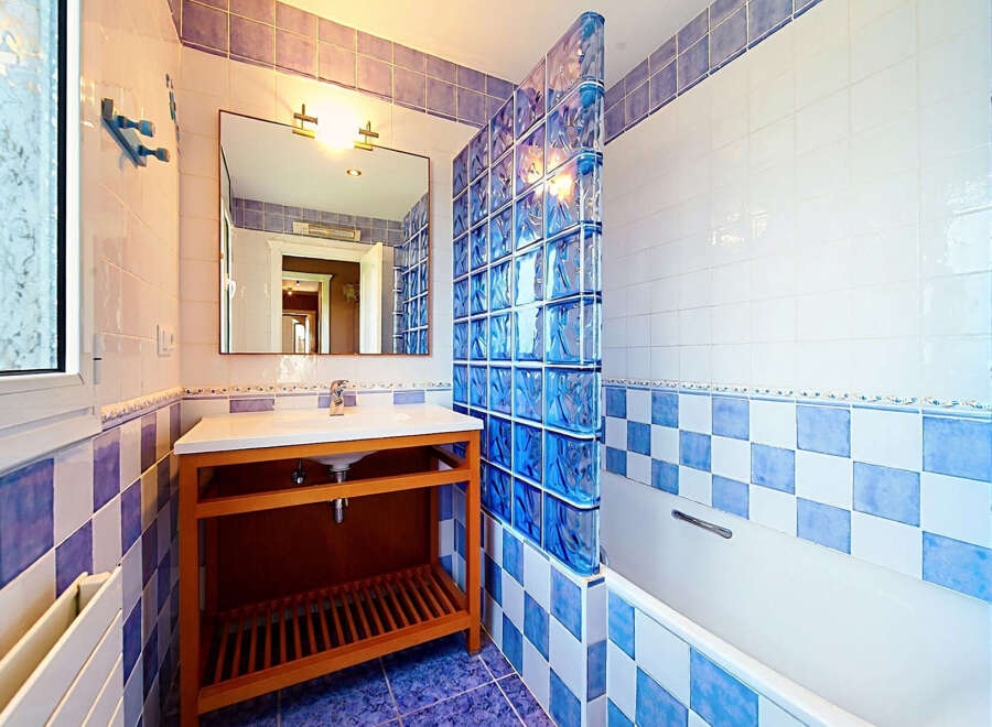 This charming bathroom features a modern vanity with ample storage and a sleek countertop.