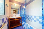 This charming bathroom features a modern vanity with ample storage and a sleek countertop.