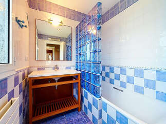 This charming bathroom features a modern vanity with ample storage and a sleek countertop.
