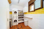 This laundry room features a stacked washer and dryer for efficient use of space.