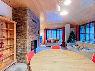 Experience cozy living in this charming mountain retreat, featuring a stunning stone fireplace and a warm, wood-paneled interior.