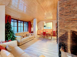 Experience cozy living in this charming mountain retreat, featuring a spacious living area with a stone fireplace and a dining nook perfect for family gatherings.