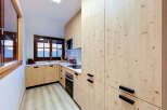 Discover this charming kitchen featuring light wood cabinetry and a sleek white countertop.